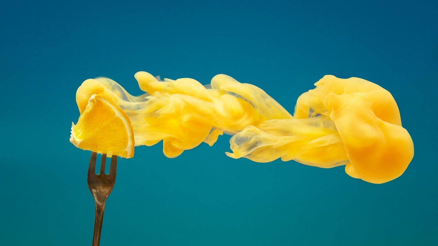 orange smoke and fruit on a fork