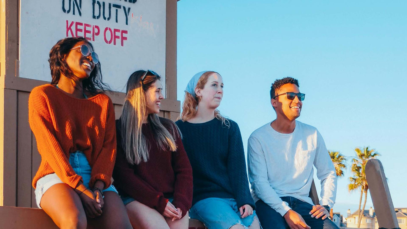 group of friends sitting in a lifeguard tower