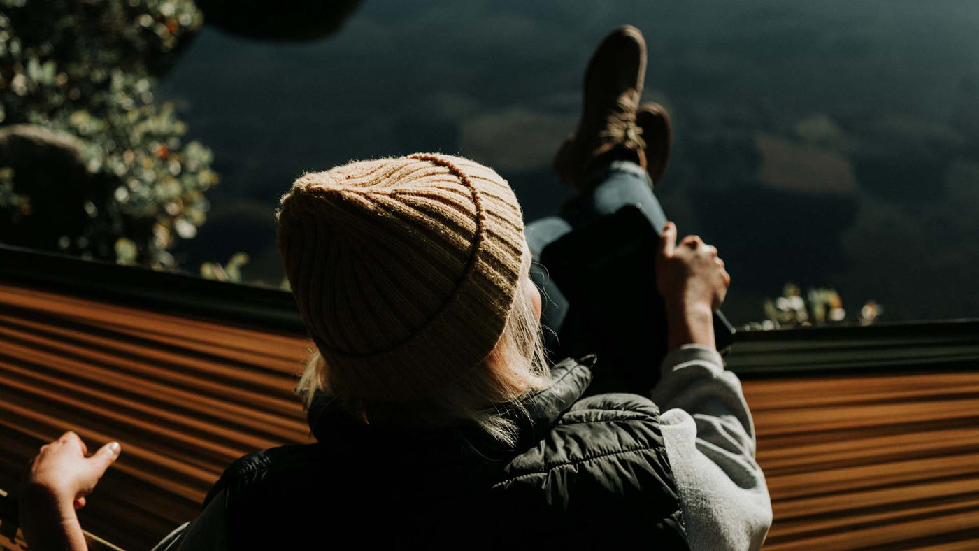 woman sitting on brown hammock