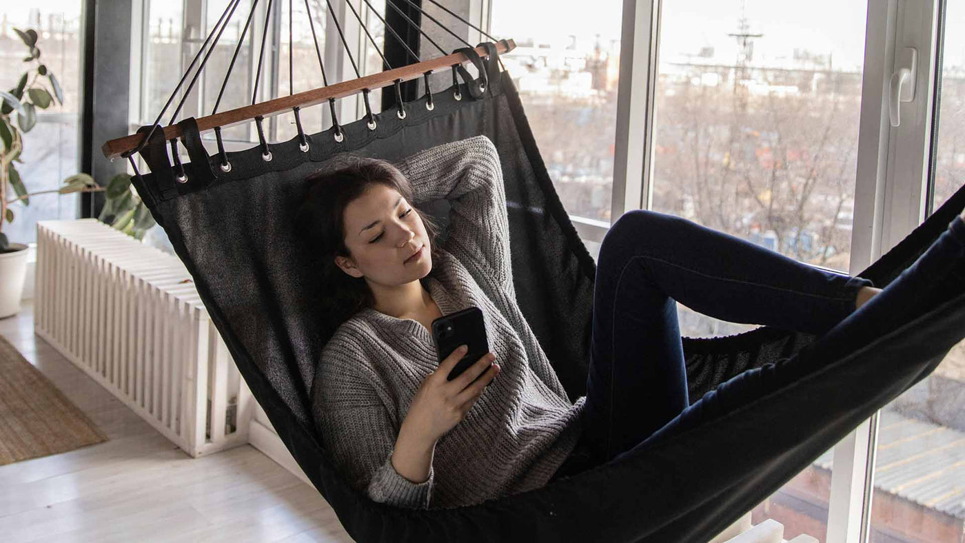 woman in a hammock reading a book